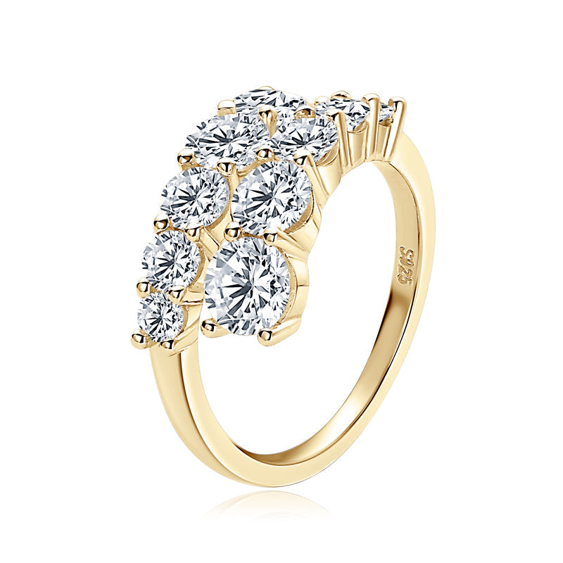 Gold ring with clear gemstones on a white background